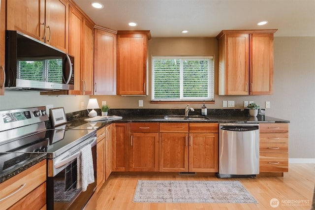 8070 Kispiox Rd, Blaine, WA 98230 - kitchen with stainless steel appliances, a sink, light wood finished floors, dark stone countertops, and recessed lighting