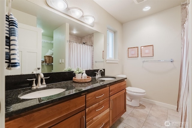 8070 Kispiox Rd, Blaine, WA 98230 - full bathroom with tile patterned flooring, double vanity, toilet, baseboards, and a shower with shower curtain