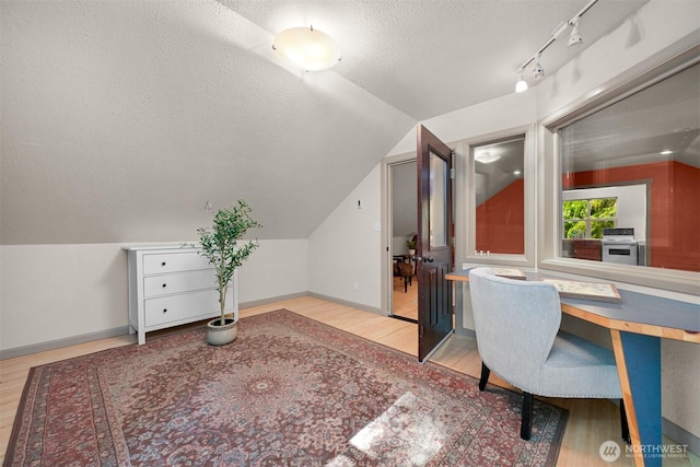 9591 W 34th Cres, Blaine, WA 98230 - office space featuring wood finished floors, lofted ceiling, a textured ceiling, and baseboards