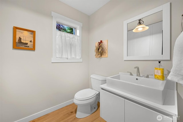 9591 W 34th Cres, Blaine, WA 98230 - bathroom featuring wood finished floors, baseboards, toilet, and vanity