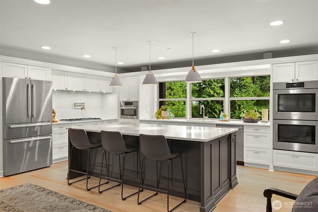 9591 W 34th Cres, Blaine, WA 98230 - kitchen with stainless steel appliances, light countertops, backsplash, white cabinetry, and recessed lighting
