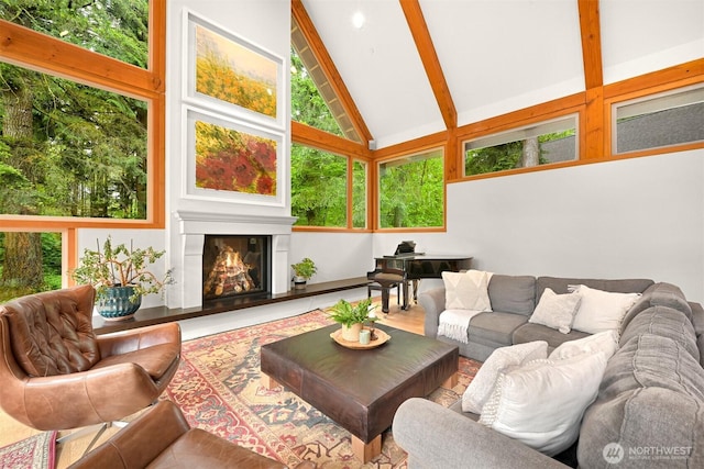9591 W 34th Cres, Blaine, WA 98230 - living room featuring beam ceiling, high vaulted ceiling, and a glass covered fireplace