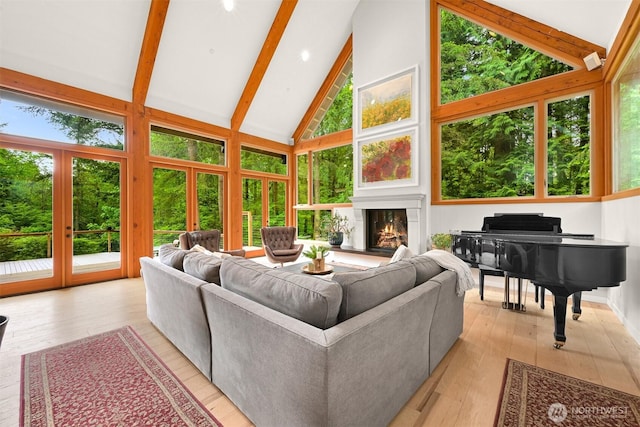 9591 W 34th Cres, Blaine, WA 98230 - living room with high vaulted ceiling, light wood-style floors, beam ceiling, and a glass covered fireplace