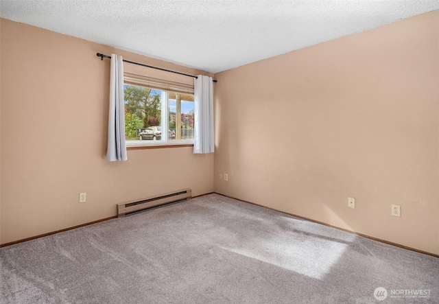 carpeted empty room featuring baseboard heating, baseboards, and a textured ceiling