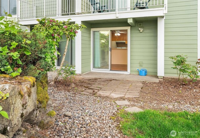 property entrance featuring a balcony and a patio area