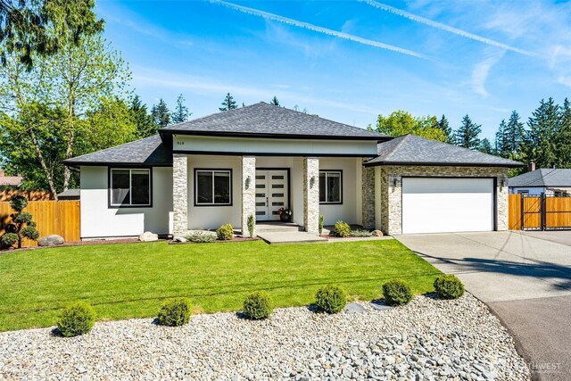 prairie-style house featuring driveway, a garage, stone siding, a shingled roof, and stucco siding