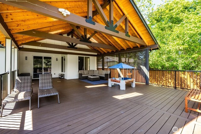 wooden deck with an outdoor hangout area and a ceiling fan