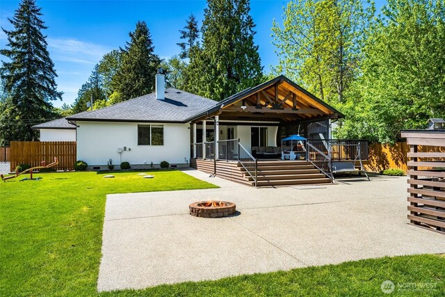 back of house featuring an outdoor fire pit, a chimney, a patio, and a shingled roof