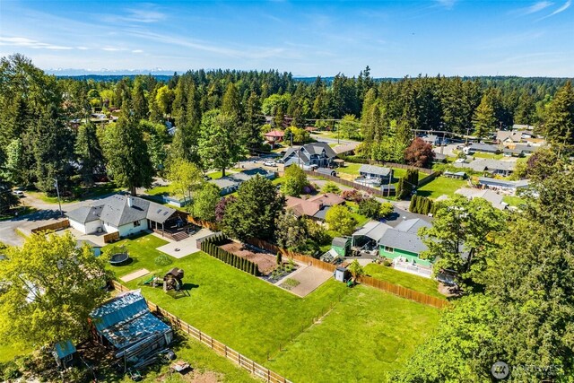 aerial view of residential area featuring a forest