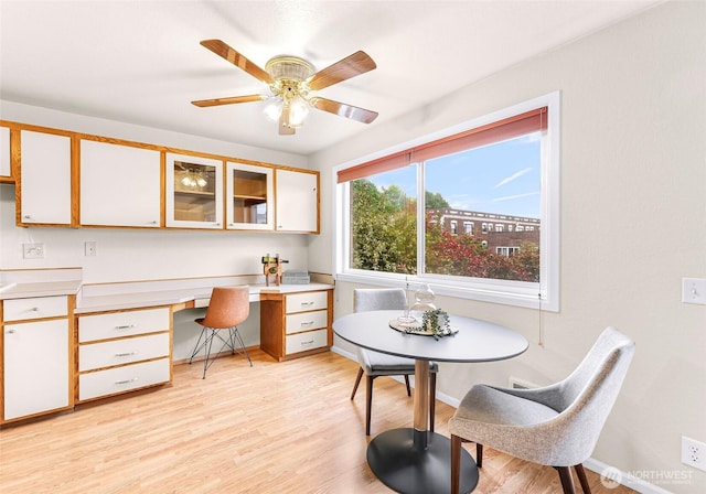 2619 Rucker Ave Unit 4, Everett, WA 98201 - dining area with light wood finished floors, a ceiling fan, and baseboards