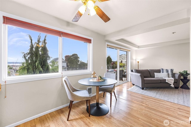 2619 Rucker Ave Unit 4, Everett, WA 98201 - dining room with healthy amount of natural light, light wood finished floors, ceiling fan, and baseboards