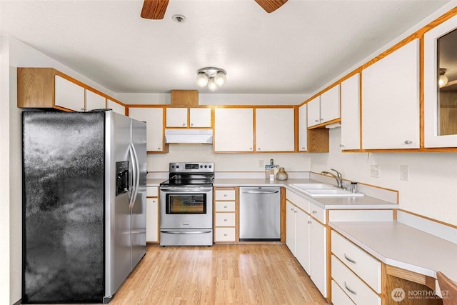 2619 Rucker Ave Unit 4, Everett, WA 98201 - kitchen featuring stainless steel appliances, a sink, under cabinet range hood, ceiling fan, and light wood finished floors
