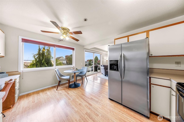 2619 Rucker Ave Unit 4, Everett, WA 98201 - kitchen with stainless steel fridge, healthy amount of natural light, a ceiling fan, and light wood-style floors