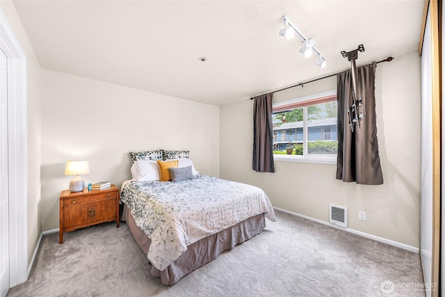 2619 Rucker Ave Unit 4, Everett, WA 98201 - bedroom featuring light colored carpet, baseboards, and track lighting