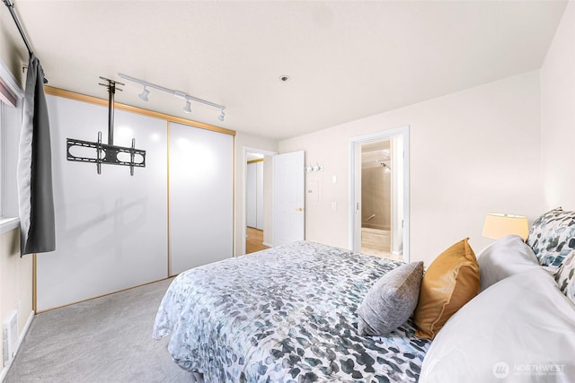 2619 Rucker Ave Unit 4, Everett, WA 98201 - bedroom featuring light colored carpet, a closet, track lighting, and connected bathroom