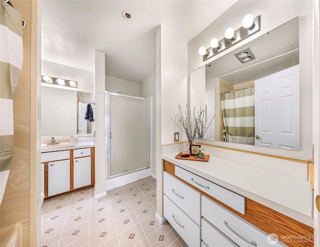 2619 Rucker Ave Unit 4, Everett, WA 98201 - bathroom featuring a stall shower, vanity, a textured ceiling, and baseboards
