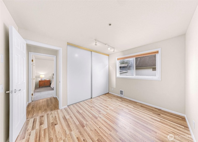 2619 Rucker Ave Unit 4, Everett, WA 98201 - unfurnished bedroom featuring light wood-style floors, a closet, and baseboards