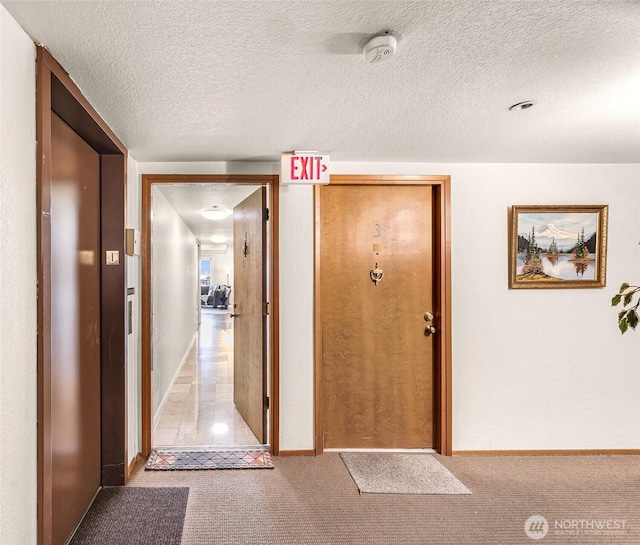2619 Rucker Ave Unit 4, Everett, WA 98201 - hall featuring carpet flooring, elevator, baseboards, and a textured ceiling