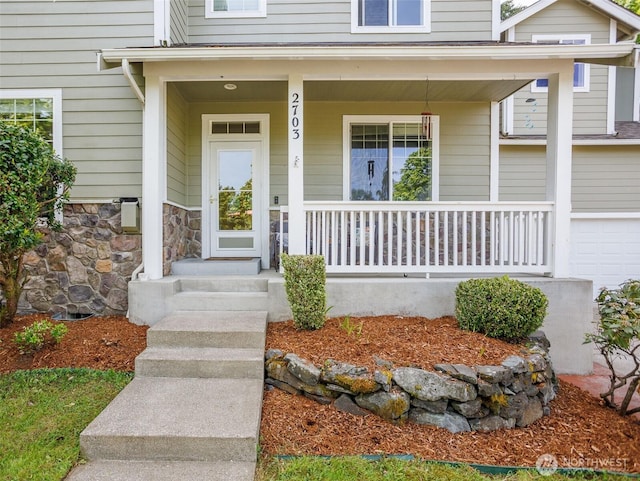 doorway to property featuring covered porch