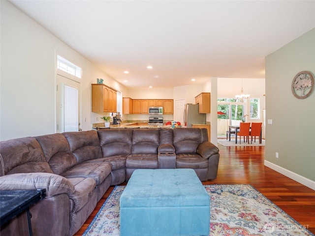 living area featuring wood finished floors, plenty of natural light, a chandelier, baseboards, and recessed lighting