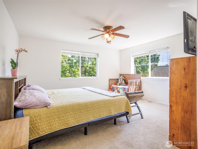 bedroom with carpet, a ceiling fan, and baseboards
