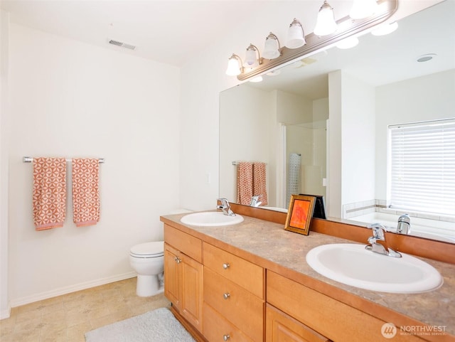 full bath featuring a shower stall, baseboards, toilet, and double vanity