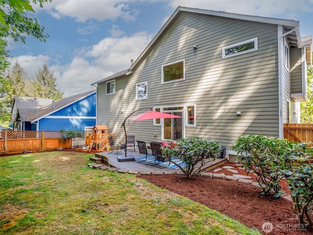 rear view of property with a wooden deck