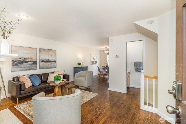living area with dark wood finished floors and baseboards