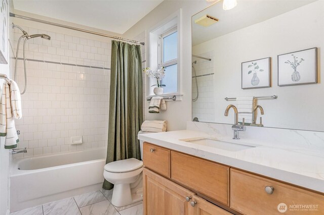 bathroom with shower / bathtub combination with curtain, toilet, and vanity