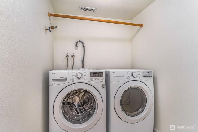 washroom featuring independent washer and dryer