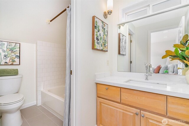 bathroom with tile patterned floors, toilet, vanity, baseboards, and shower / bath combination with curtain