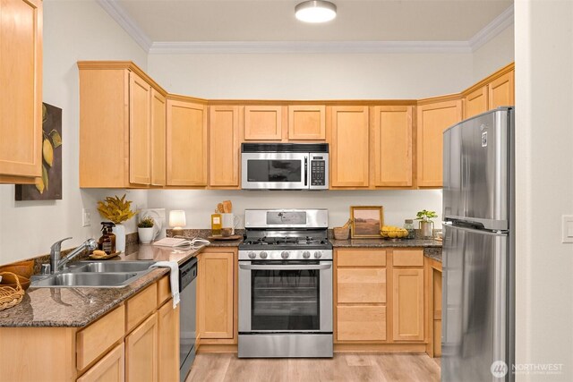kitchen with stainless steel appliances, light brown cabinetry, ornamental molding, light wood-style floors, and a sink