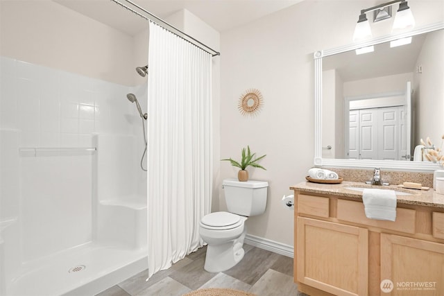 full bath with toilet, curtained shower, wood finished floors, and vanity
