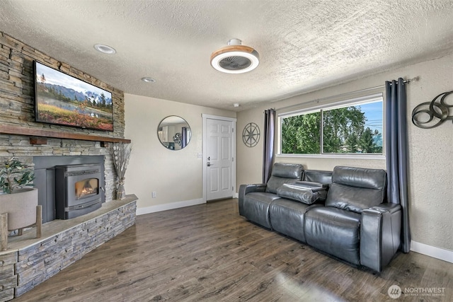1835 E Smith Rd, Bellingham, WA 98226 - living room featuring a textured ceiling, wood finished floors, a fireplace, and baseboards