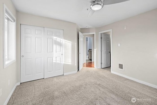 13426 97th Ave E Unit 204, Puyallup, WA 98373 - unfurnished bedroom with carpet flooring, baseboards, and a closet