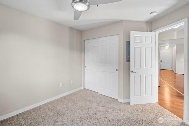 13426 97th Ave E Unit 204, Puyallup, WA 98373 - unfurnished bedroom featuring a closet, baseboards, carpet flooring, and a ceiling fan