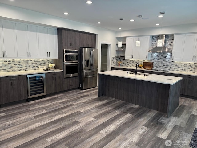 25117 235th Ct SE, Maple Valley, WA 98038 - kitchen featuring appliances with stainless steel finishes, wall chimney exhaust hood, beverage cooler, a sink, and dark wood-style flooring