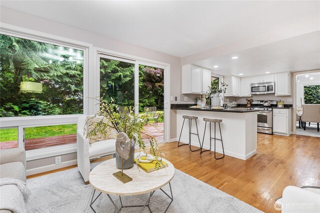 21016 NE 33rd Pl, Sammamish, WA 98074 - living area with light wood-type flooring, plenty of natural light, recessed lighting, and baseboards