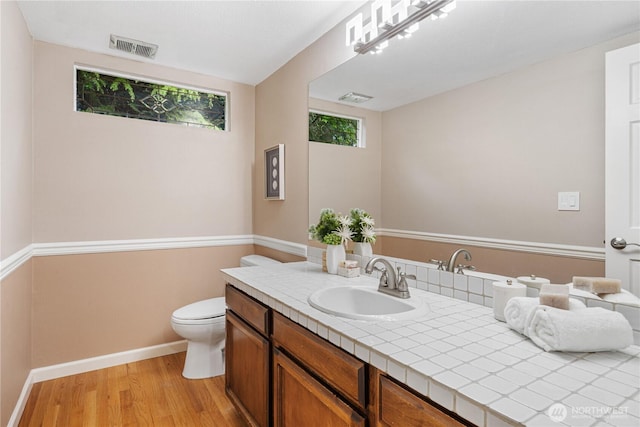 21016 NE 33rd Pl, Sammamish, WA 98074 - bathroom featuring wood finished floors, vanity, toilet, and baseboards