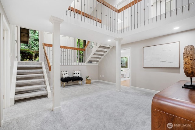 21016 NE 33rd Pl, Sammamish, WA 98074 - living area with stairs, ornate columns, carpet floors, a high ceiling, and baseboards