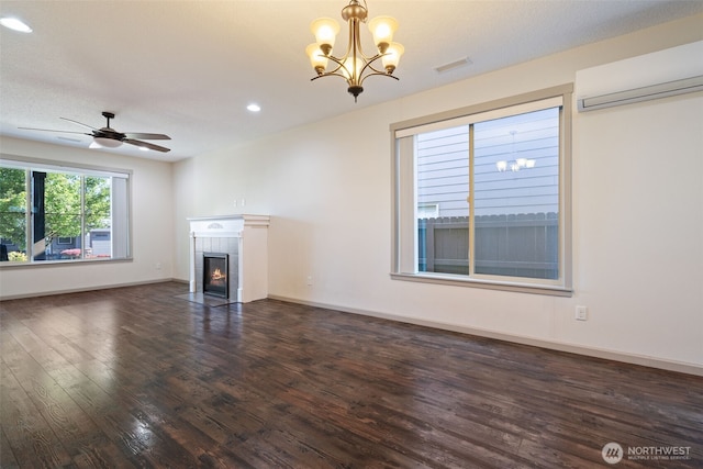 15325 NE 106th St, Vancouver, WA 98682 - unfurnished living room with an AC wall unit, dark wood-style flooring, a tiled fireplace, a chandelier, and recessed lighting