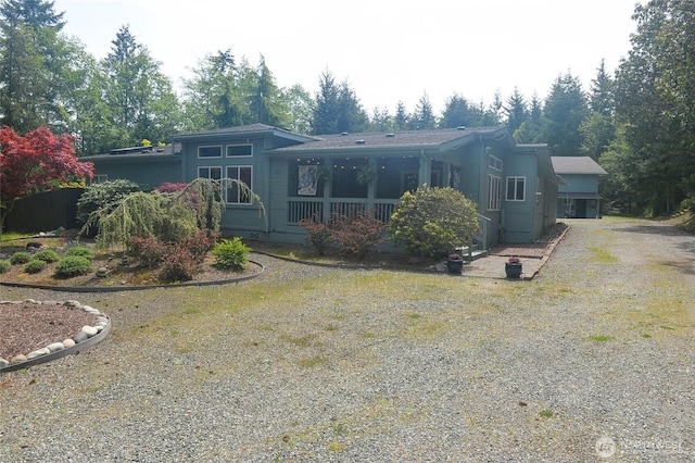 back of property with dirt driveway