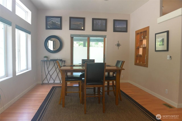 dining room featuring wood finished floors and baseboards