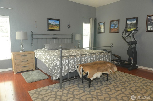bedroom with wood finished floors and baseboards