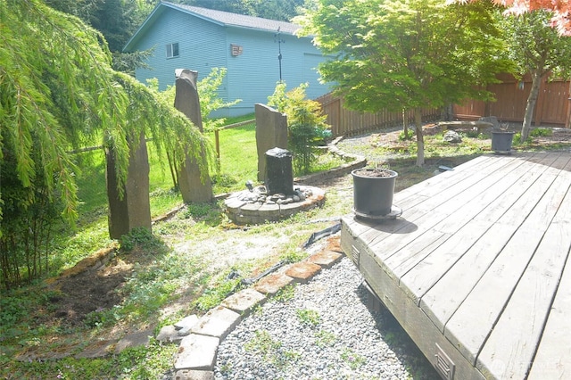 view of yard featuring a deck and fence
