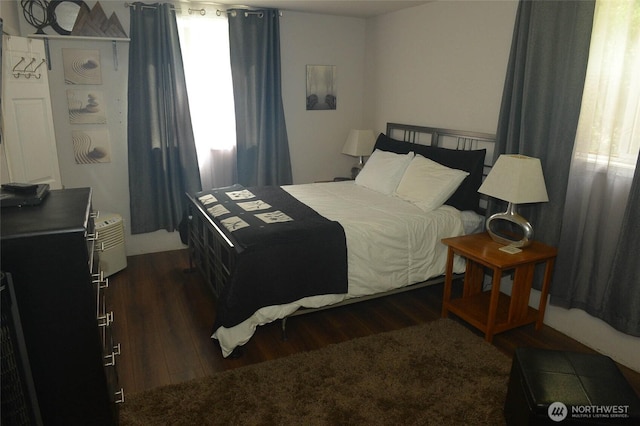 bedroom featuring dark wood finished floors