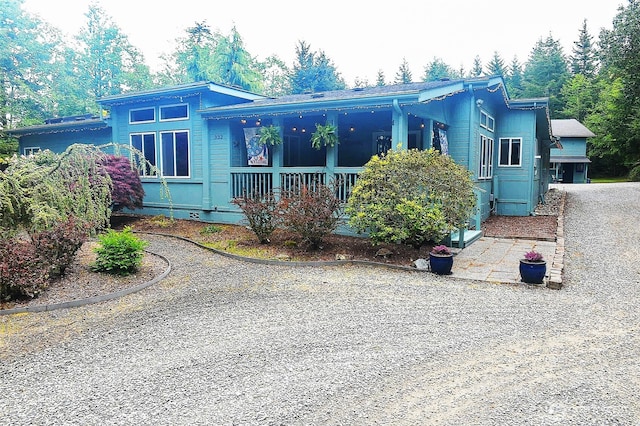 332 Rhododendron Dr, Sequim, WA 98382 - view of front facade featuring gravel driveway and a porch