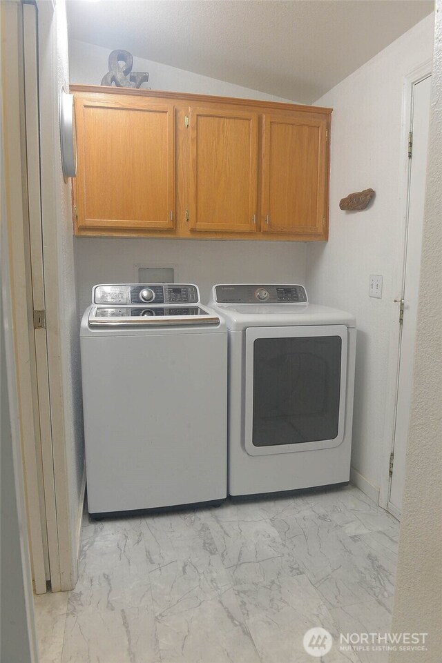 332 Rhododendron Dr, Sequim, WA 98382 - laundry room featuring cabinet space, light marble finish flooring, and washing machine and dryer