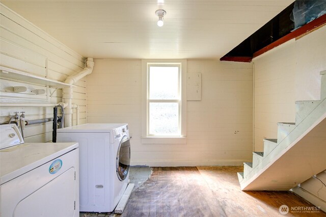laundry area featuring washing machine and dryer and wood finished floors