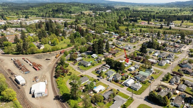 view of property location with a heavily wooded area and nearby suburban area